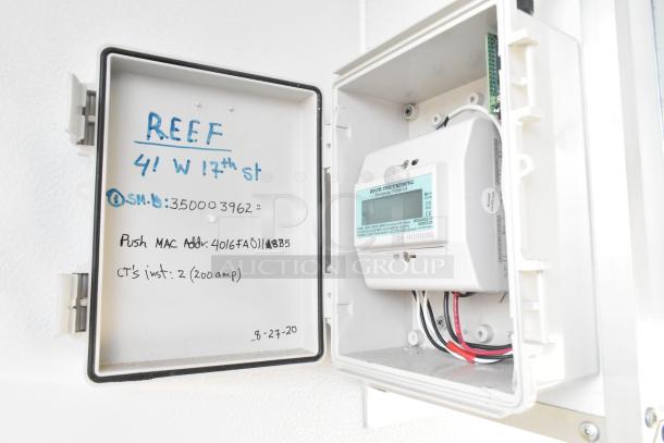 Electrical panel in Southern Dimensions food trailer, showing EKM Metering Omnimeter Pulse v.4. Marked with address details and installation info.