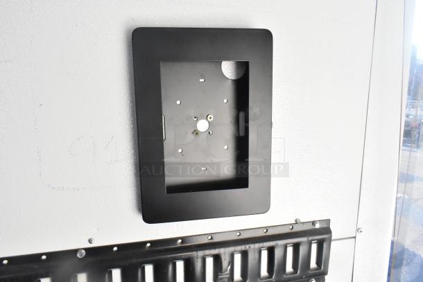 Southern Dimensions Shell food trailer interior wall with black metal mounting bracket. Ready for customization.