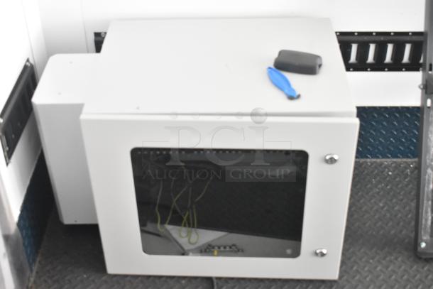 Southern Dimensions Shell food trailer interior with storage cabinet, wiring visible. Ready for equipment installation.