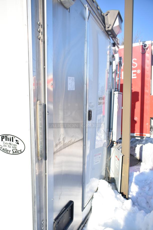 ATX 28' unbranded cold food trailer, stainless steel exterior, equipped with Arctic Air units, grease hood, clear title.