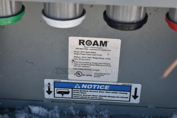 Alt text: "Close-up of Roam Technologies label on power input panel; details include model MTC 6001 IESK2, 240V, UL listed."