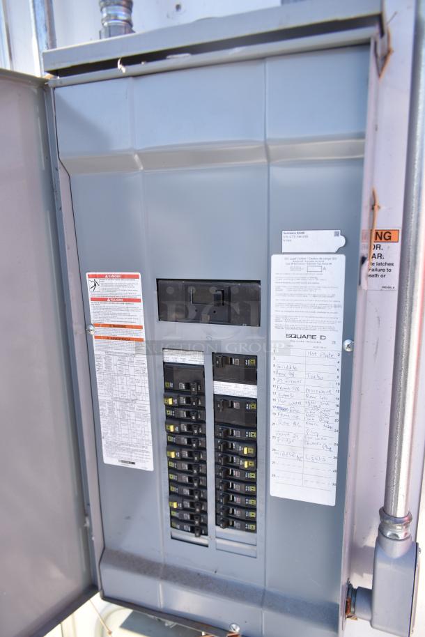 Electrical panel in ATX 28' cold food trailer; labeled circuit breakers, warning labels, and handwritten notes visible.