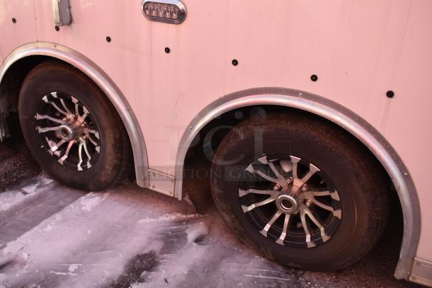 ATX 28' trailer wheels and side panel, featuring a double axle design and metallic fenders.