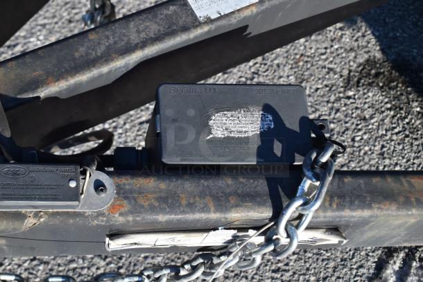 ATX 28' trailer hitch close-up with visible ESCO breakaway switch and chains. Rust marks on the hitch.