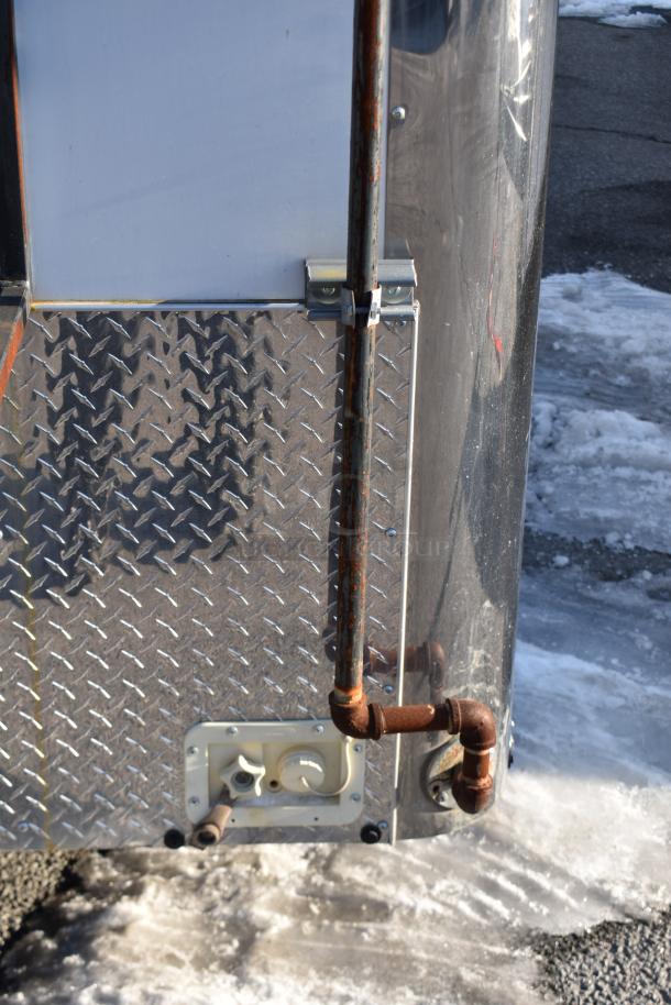 ATX 28' cold food and beverage trailer, diamond plate exterior, rusted piping, and utility hookup; ready for use.