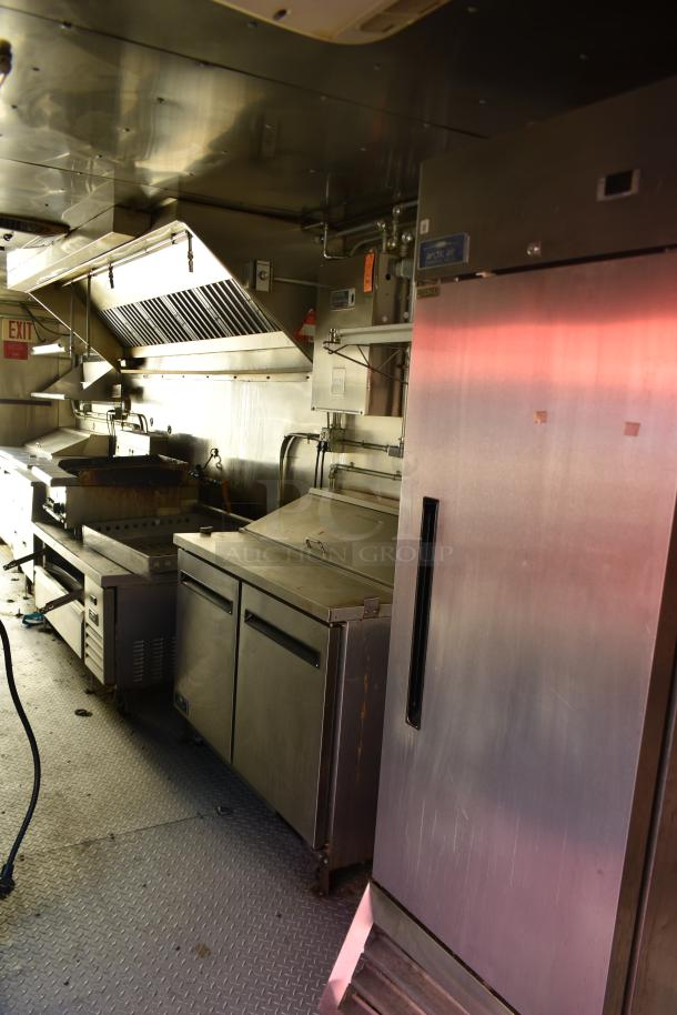 28' ATX food trailer interior with Arctic Air prep tables, coolers, freezers, charbroiler, grease hood, and suppression system.