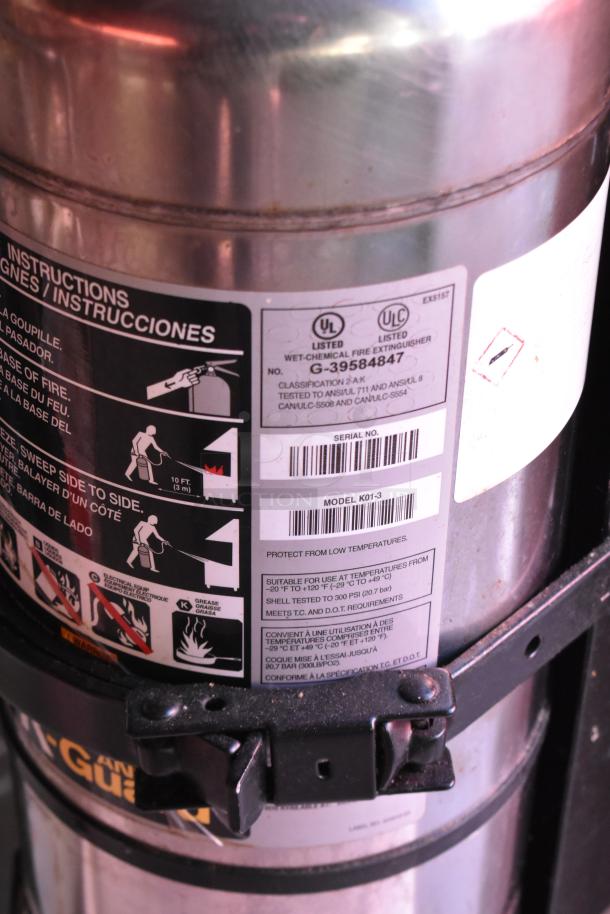 Close-up of a wet-chemical fire extinguisher with model K01-3 label, UL listed, temperature range -20°F to 120°F.