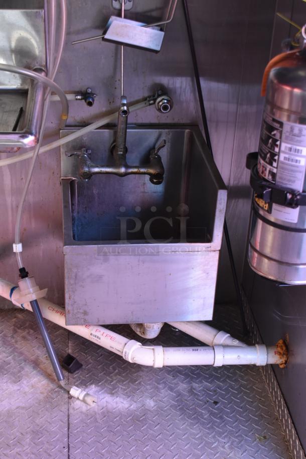 Interior sink view of ATX 28' cold food trailer, showing industrial setup with commercial-grade fixtures and plumbing.