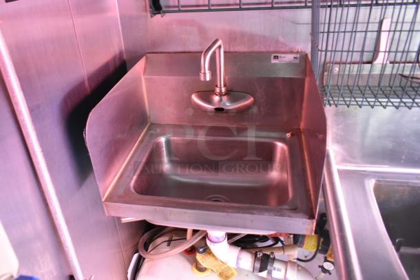 Stainless steel sink with gooseneck faucet in a 28' ATX food trailer. Commercial-grade fixture.