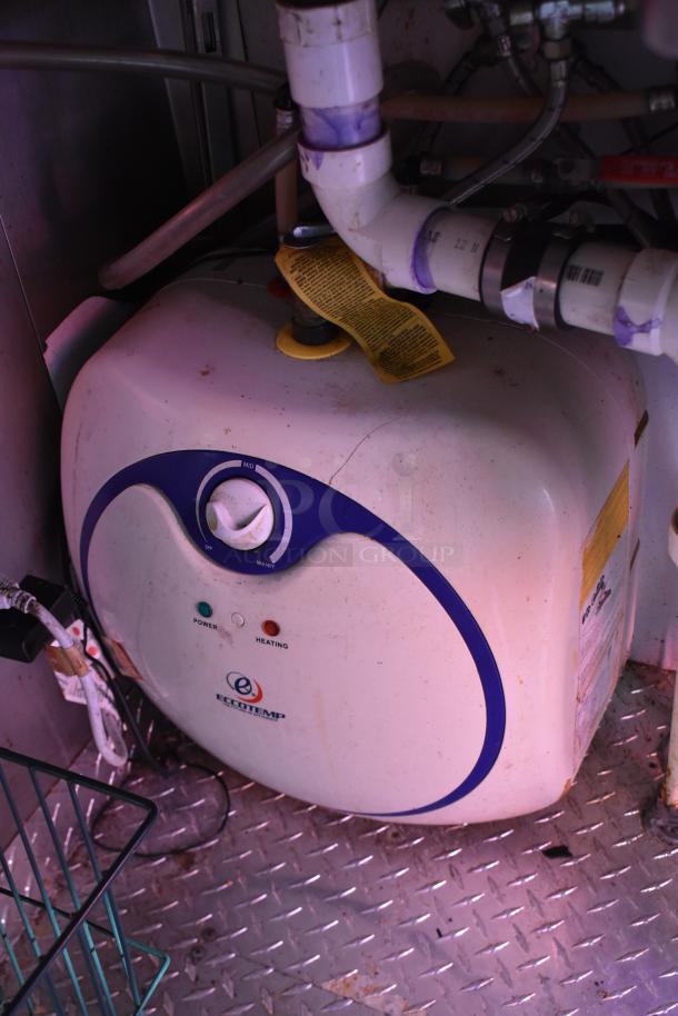 ATX 28' cold food/beverage trailer interior with Eccotemp water heater, piping, and diamond plate flooring.