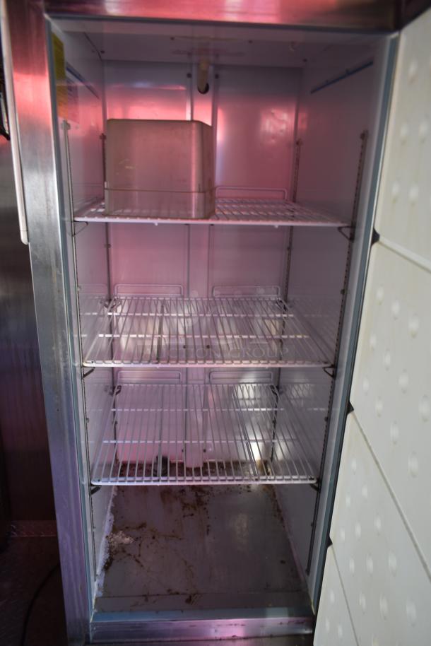 Interior of ATX 28' mobile trailer showing a commercial stainless steel cooler with empty wire racks, ready for use.