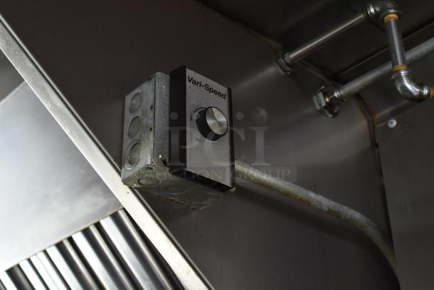 Control dial labeled "Vari-Speed" on metal surface inside a food trailer. Features settings for high and off.