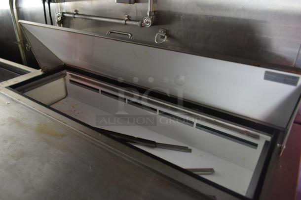 Interior view of Arctic Air commercial prep table inside 28' ATX cold food and beverage trailer, showing open compartment.