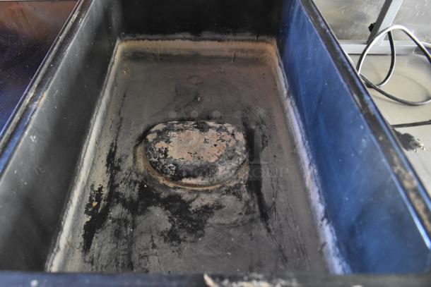 Interior view of a used ATX 28' food trailer, showing a heavily soiled section with signs of wear and electrical cables.