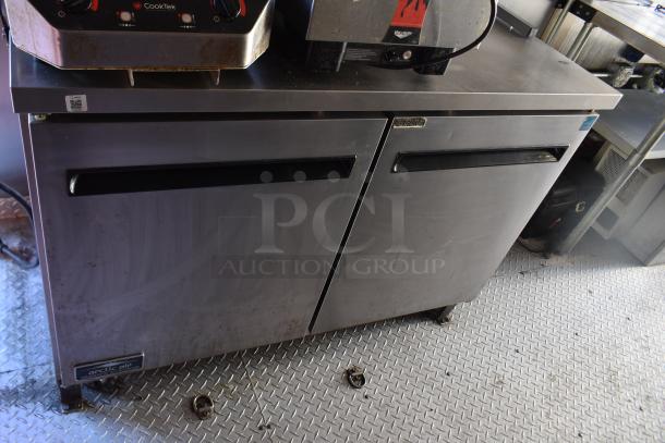 ATX 28' unbranded trailer interior with Arctic Air equipment, featuring stainless steel prep table and cooler. Slight wear visible.