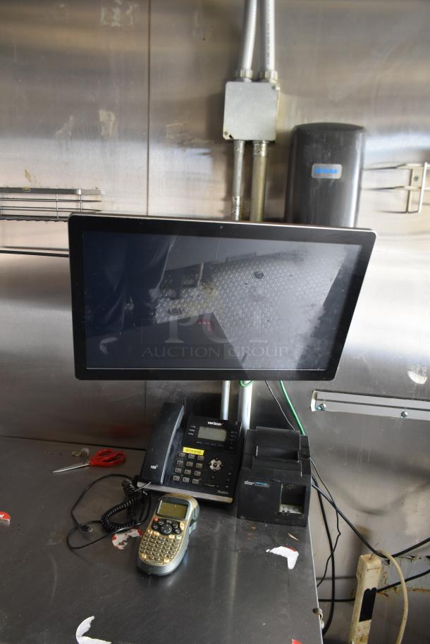 Interior setup of ATX 28' cold food trailer featuring a computer monitor, Verizon phone, label printer, and other communication equipment.
