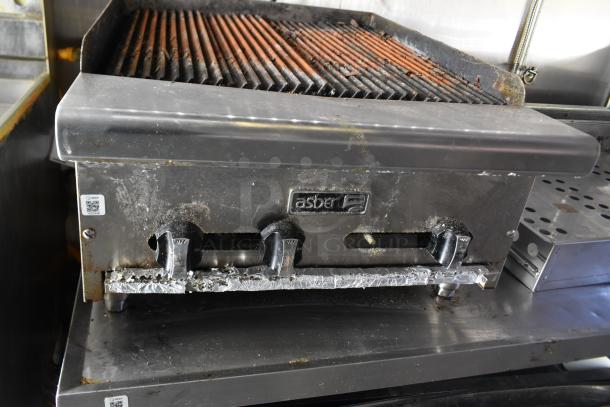 Asber charbroiler with visible controls and grill, part of a fully outfitted cold food trailer setup.