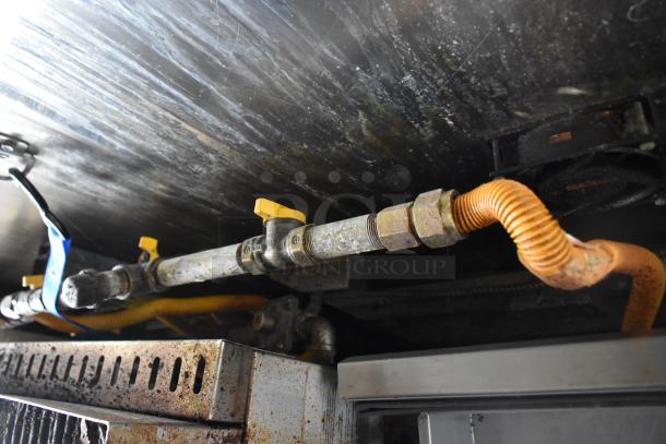 ATX 28' trailer gas line system with yellow valve and orange tubing, showing undercarriage details.