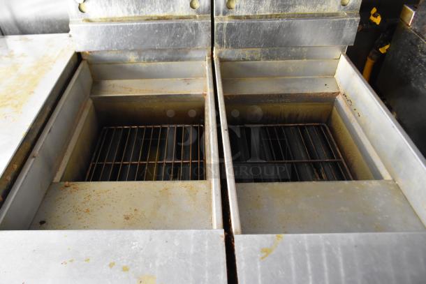 Close-up of the interior metallic cooking surfaces inside the ATX 28' food and beverage trailer, featuring grill racks.