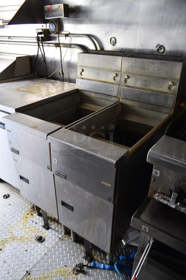 Interior of ATX 28' food trailer showing commercial-grade Pitco fryers, used condition, on non-slip metal floor.