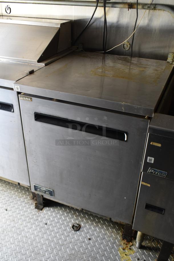 ATX 28' trailer interior showing Arctic Air commercial freezer with prep surface. Stainless steel, used condition.