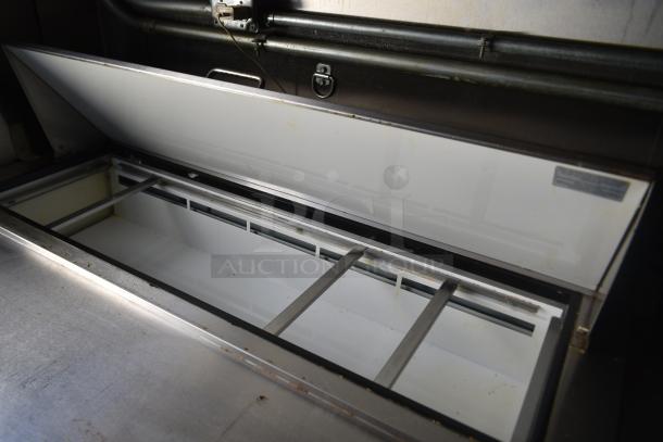 ATX 28' cold food trailer's Arctic Air prep table with open stainless steel lid, ready for use.