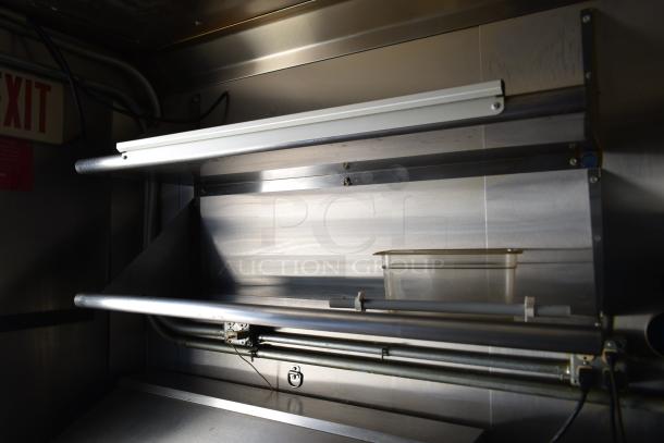 Interior of ATX 28' cold food and beverage trailer featuring stainless steel shelving and prep area, ideal for retail use.