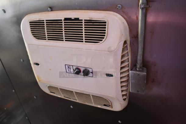 Interior wall view of ATX 28' cold food trailer showing a ventilation unit with control knobs.