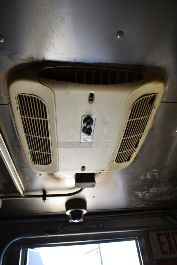 Ceiling of ATX 28' trailer showing air ventilation system and lighting fixture. Slight wear visible on the surface.