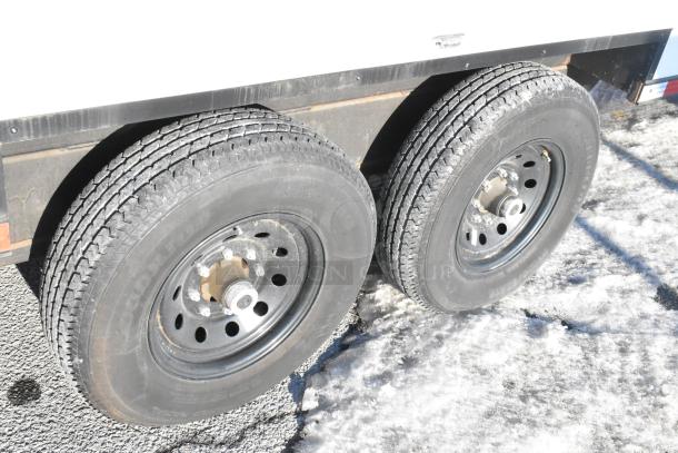 Unbranded cold food and beverage trailer with dual tires, ready for use. Features commercial-grade equipment and clear title.