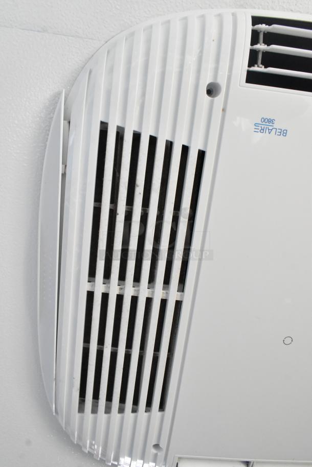 Ceiling-mounted air vent with label "BELAIRE 3800" in a retail trailer, part of commercial-grade equipment setup.