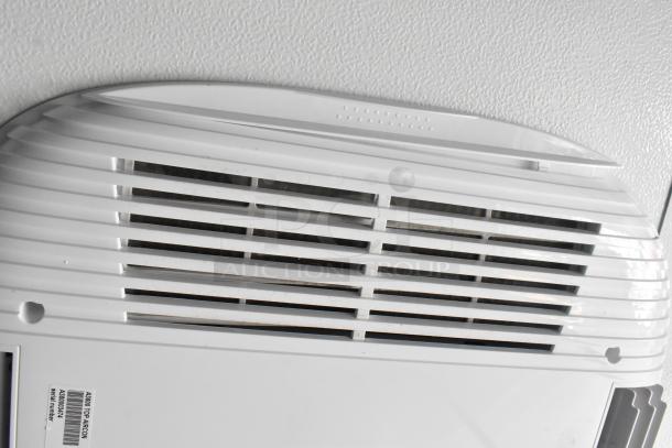 Close-up of ventilation system in a new 2021 unbranded cold food & beverage trailer, featuring detailed serial number label.