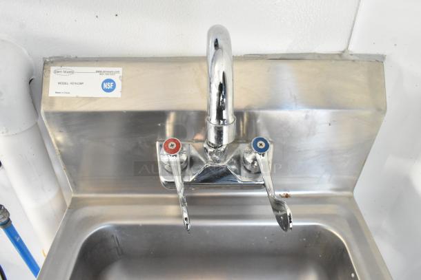 Stainless steel sink with dual-handle faucet in a food trailer. NSF label shows model HS15-CWP by Serv-Ware.