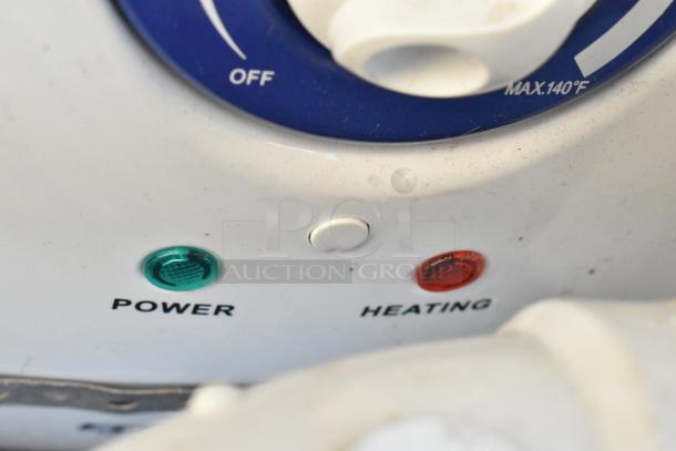 Close-up of appliance controls labeled "Power" and "Heating," with green and red indicators. Dial marked up to 140°F.