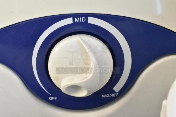 Close-up of a white and blue dial with off, mid, and max 140°F settings, likely part of a larger appliance.