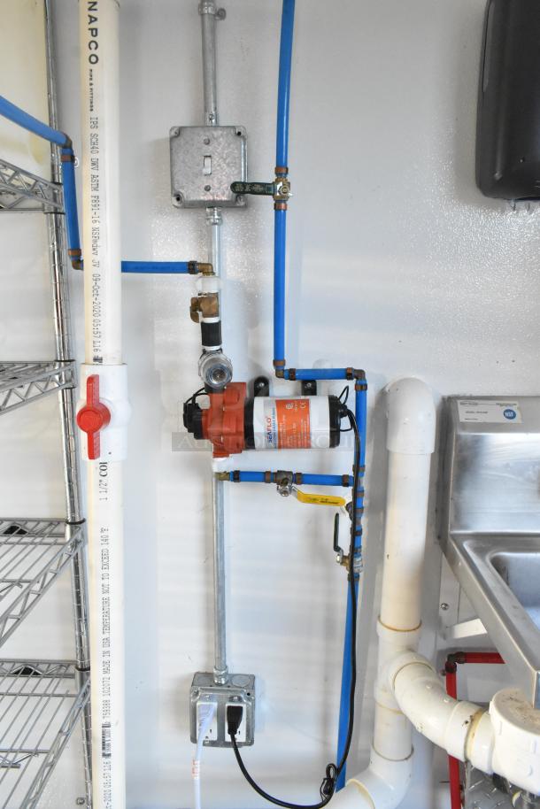 Cold food and beverage trailer interior showing piping and water filtration system. Includes NSF-certified sink and Seaflo pump.
