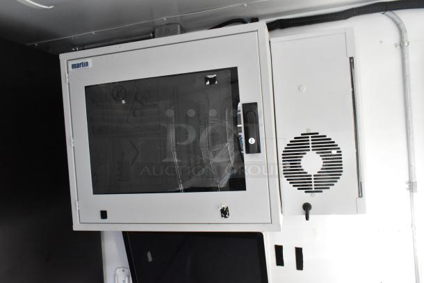Unbranded cold food trailer interior showing a Martin cabinet with a vented door, ready for commercial use.