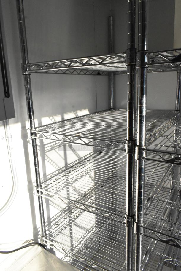 New unbranded cold food & beverage trailer; features commercial shelving for product storage. Perfect for ghost kitchens.