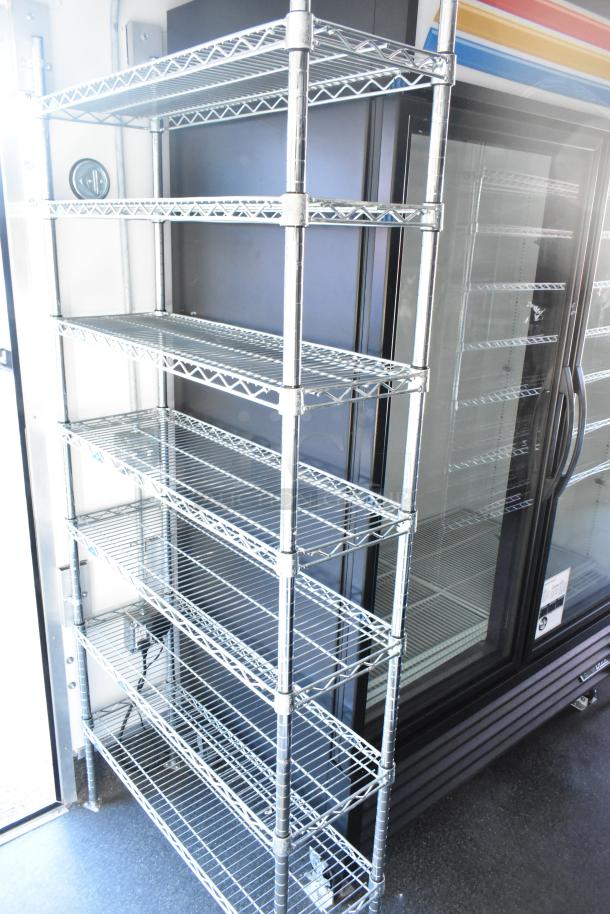 Unbranded cold food and beverage trailer featuring metal shelving and glass-door cooler. Includes True freezer and Turbo Air coolers.