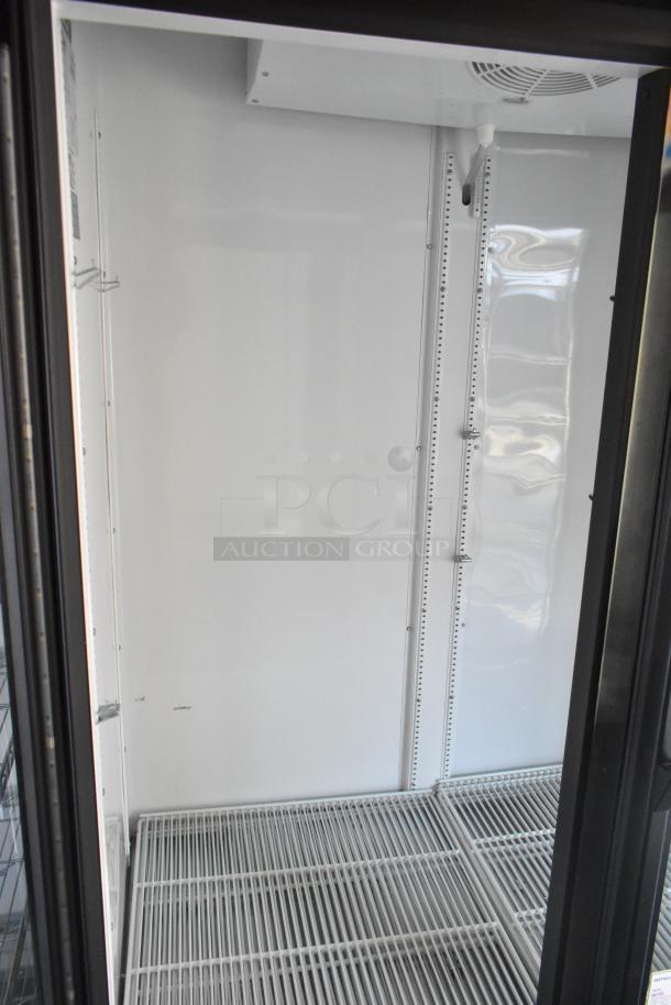 Unbranded retail trailer interior, featuring empty shelving and cooling equipment. Ideal for food or beverage setup.