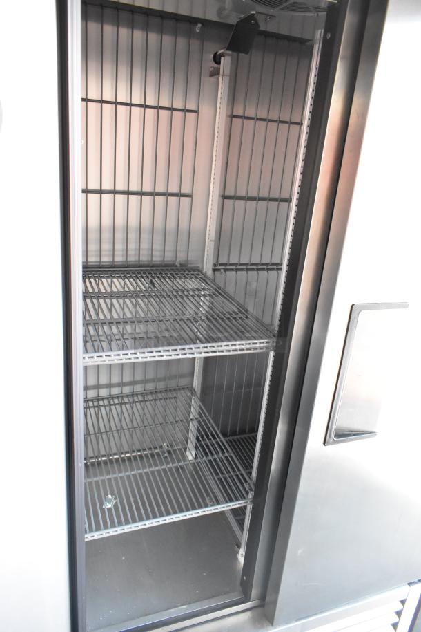 Interior of a commercial-grade True freezer with multiple wire shelves, part of a fully outfitted 2021 retail trailer.