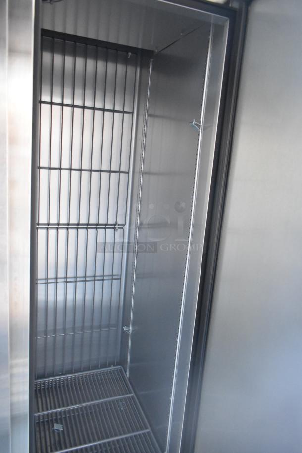 Interior of unbranded cold food trailer showing stainless steel shelving and interior. Ideal for retail or food service.