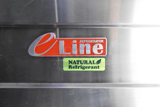 Refrigerator labels showing "e Line" brand and "Natural Refrigerant" on a stainless steel surface.