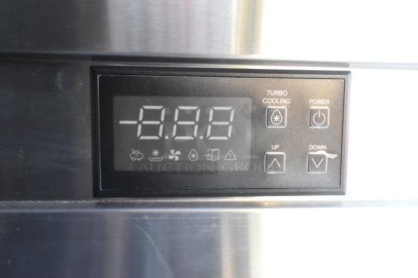 Digital display on a commercial food and beverage trailer showing temperature settings and control buttons.