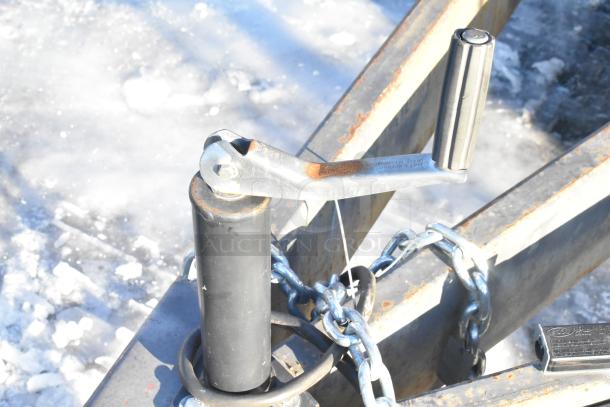Trailer hitch crank handle of a 2021 Titanium Cargo 28' food trailer. Chains secured. Ready for equipment installation.