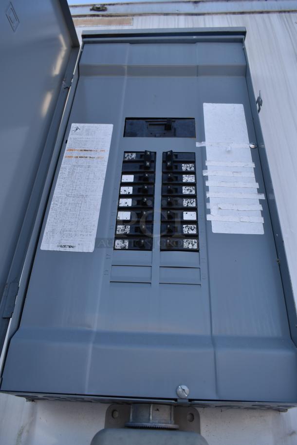 Electrical panel in the 24' Nationwide food trailer, equipped with multiple circuit breakers and labeled panels for appliance setups.