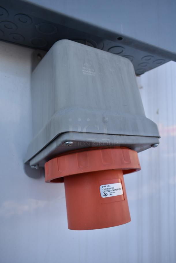 Close-up of electrical plug on a Nationwide 24' shell food trailer, featuring a 3-phase 100A socket, ready for equipment installation.