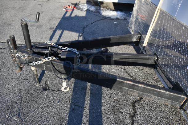 Wide-angle view of the hitch and front section of a Nationwide 24' shell food trailer. Chains and trailer jack visible.