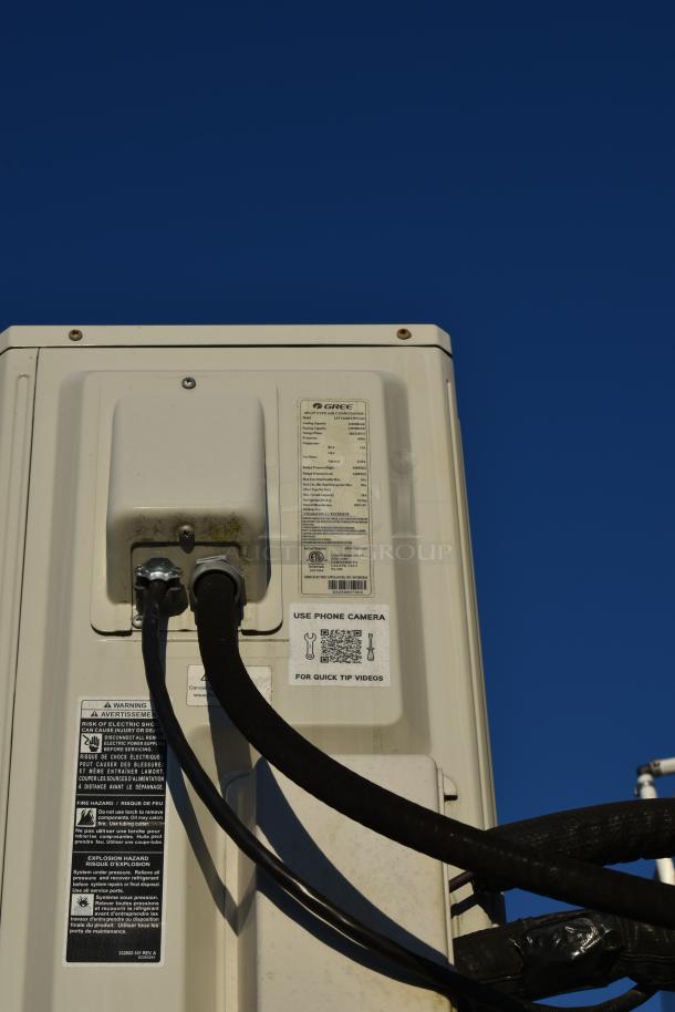 Gree air conditioning system installed in a Nationwide 24' shell food trailer. Tags show specifications and safety warnings.