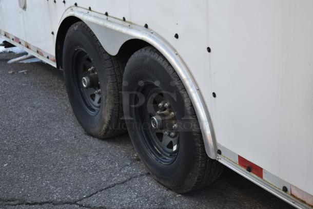 24' Nationwide shell food trailer, dual axles with black wheels, and metal fenders. Ready to be outfitted.